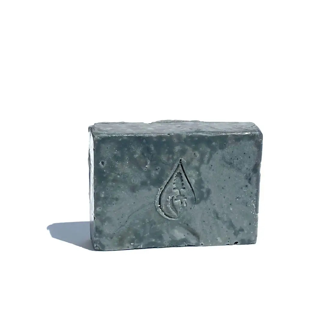 By Valenti Black Lava bar soap with a logo on a white background