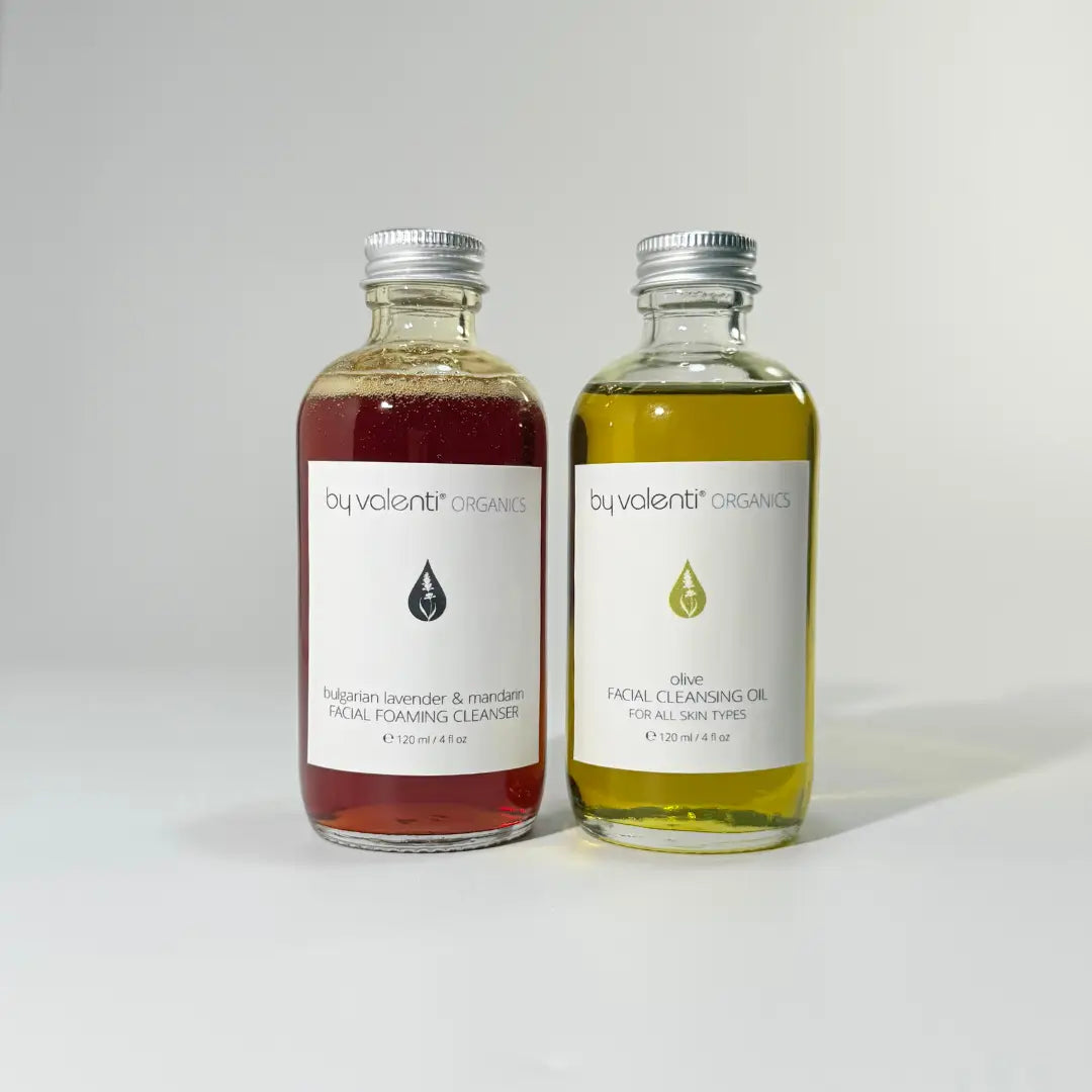 Two bottles of BY VALENTI organics facial cleansing products on a white background