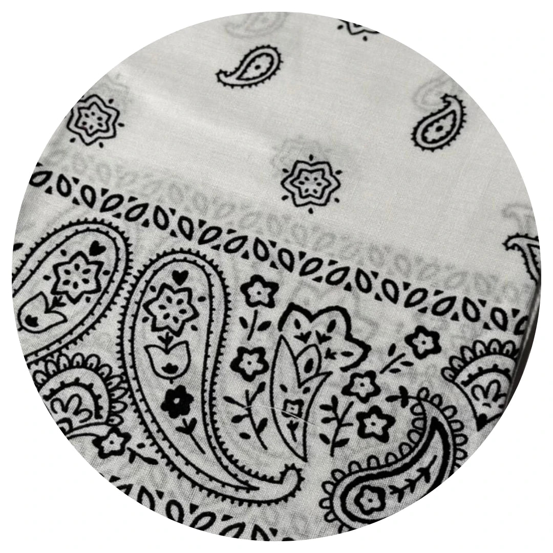 Round fabric swatch with black paisley pattern on a white background