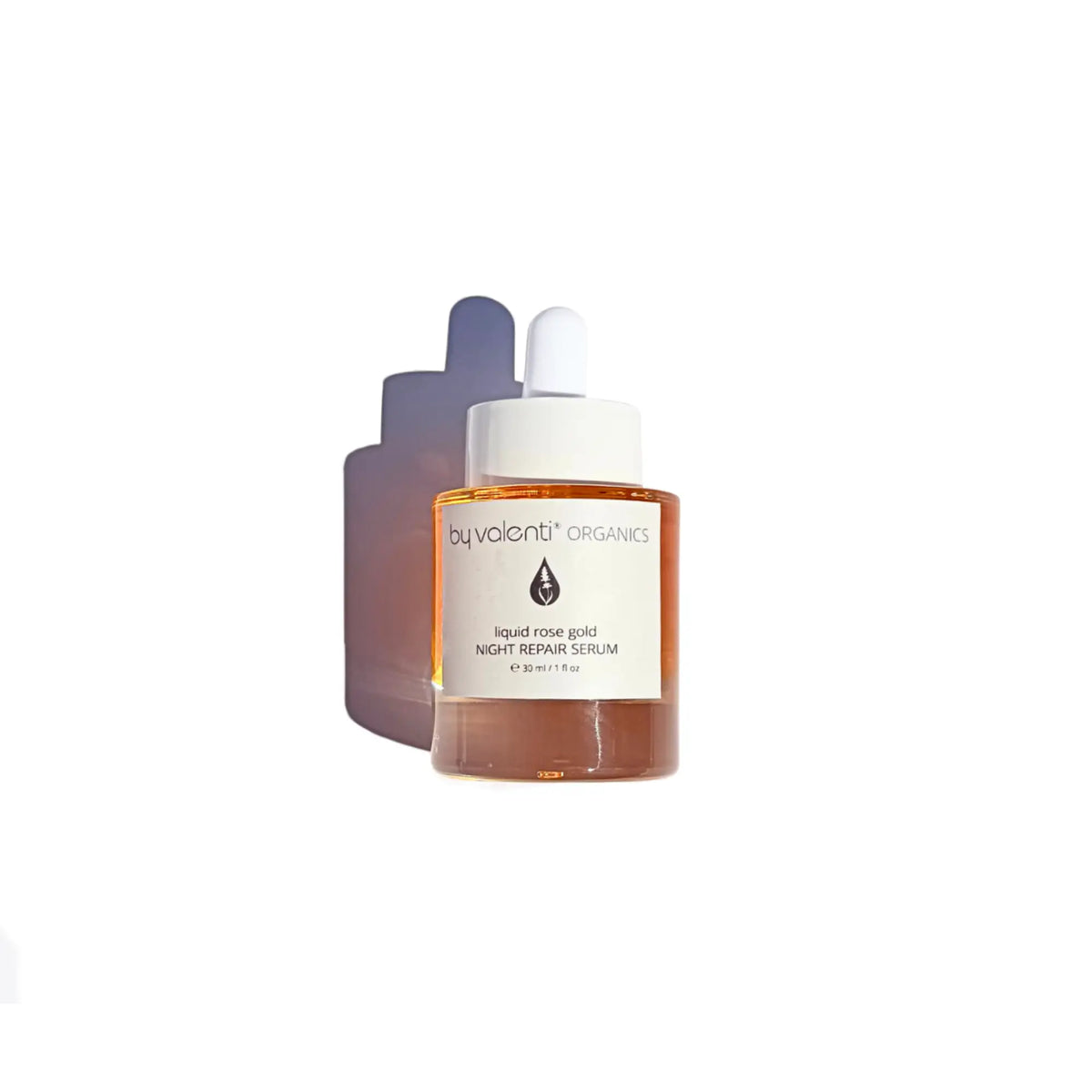 By Valenti glass bottle of vibrant orange/pink Liquid Rose Gold Night Serum with a dropped on a violet table with bright midday sunlight