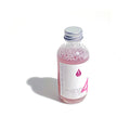 Bottle of By Valenti Italian serum with a pink liquid and a white label on a white background
