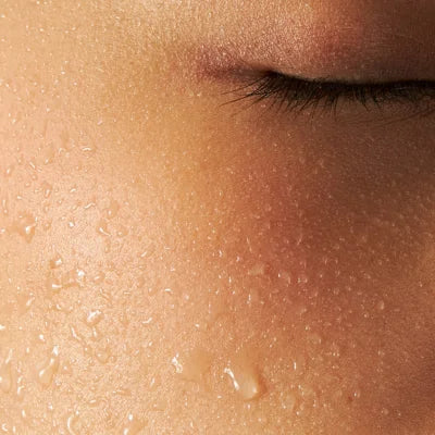 Close-up of a person's face with droplets on skin