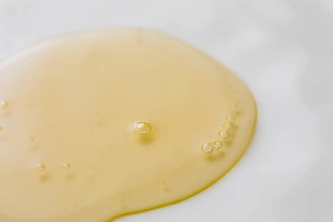 Close-up of a yellow liquid spill on a white surface